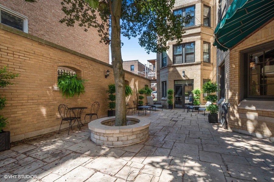 1316 Maple Avenue, Unit E1 Evanston, IL 60201 - Photo 9 of 11 a view of a patio with table and chairs and potted plants