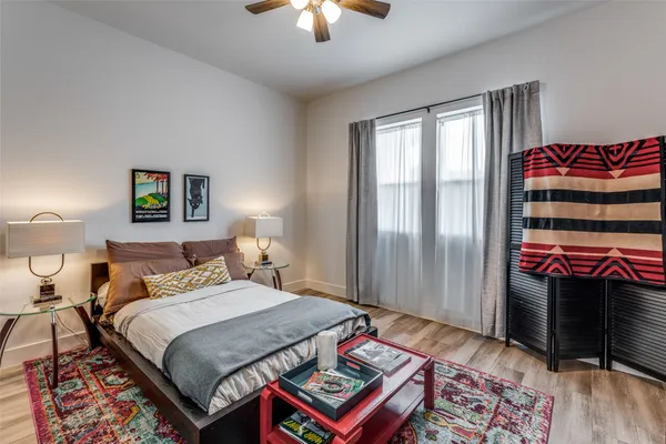 a bedroom with a bed and a chandelier