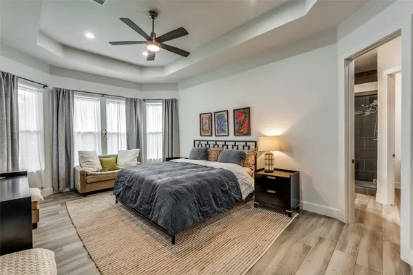 a living room with a bed furniture and a large window