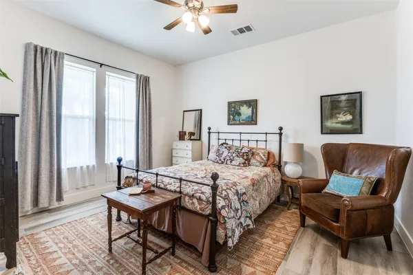 a bedroom with a bed and a couch