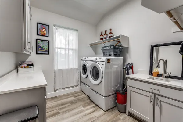 a utility room with sink dryer and washer