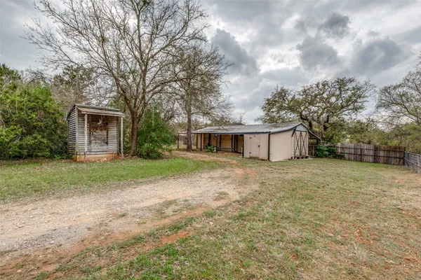 a front view of house with yard and trees