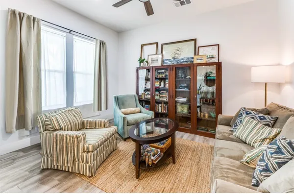 a living room with furniture and wooden floor