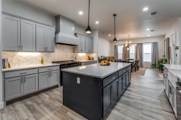 a kitchen with counter top space a sink appliances and cabinets