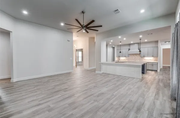 a view of kitchen with wooden floor and a window