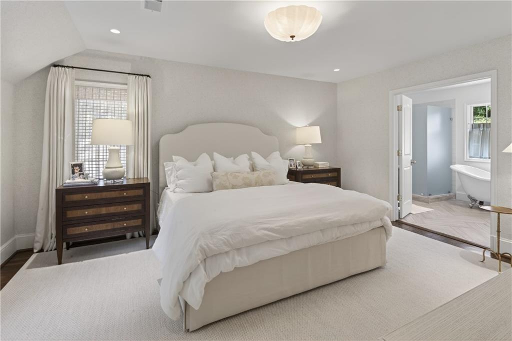 755 Greenview Avenue Northeast Atlanta, GA 30305 - Photo 12 of 28 a large bed sitting in a bedroom and chair