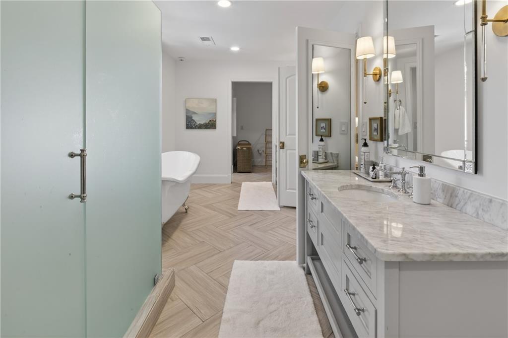 755 Greenview Avenue Northeast Atlanta, GA 30305 - Photo 14 of 28 a large bathroom with a granite countertop sink a toilet a mirror and shower