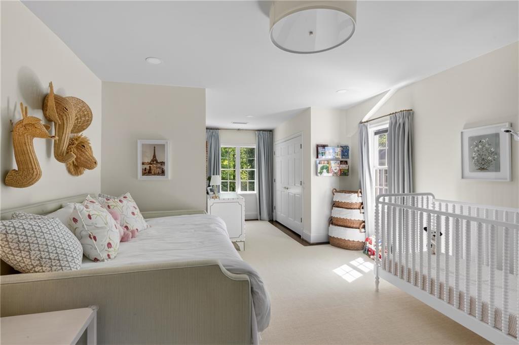 755 Greenview Avenue Northeast Atlanta, GA 30305 - Photo 18 of 28 a bedroom with a bed and glass door
