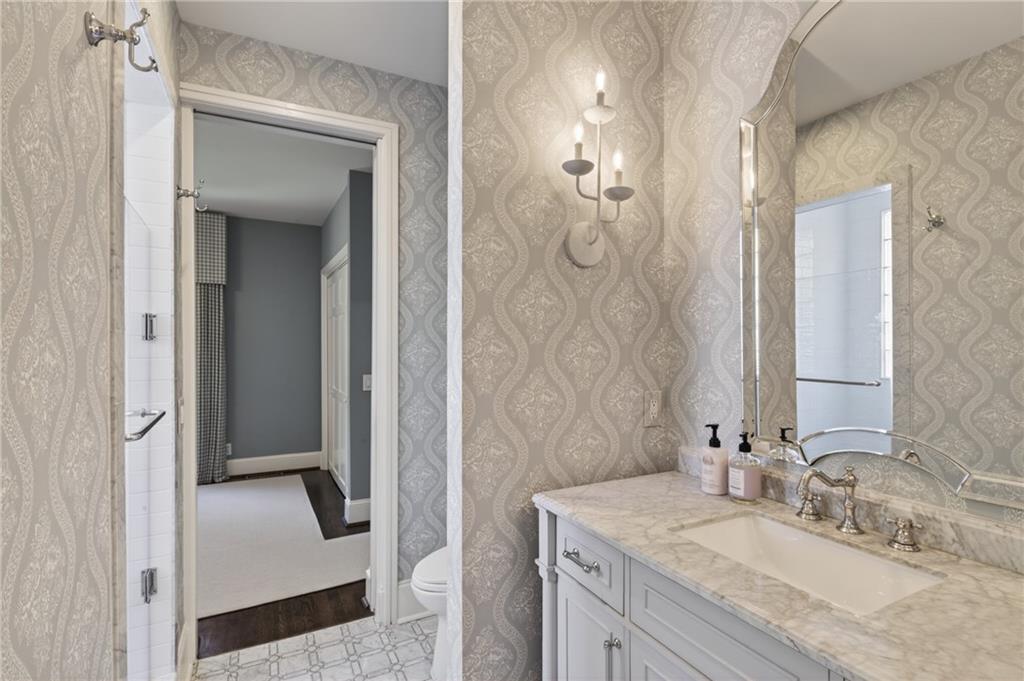 755 Greenview Avenue Northeast Atlanta, GA 30305 - Photo 25 of 28 a en suite bathroom with a granite countertop sink and a mirror
