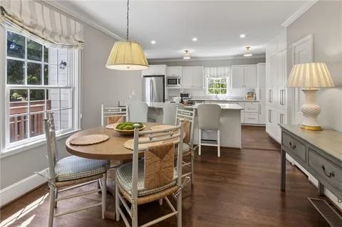 a dining room with furniture a window and kitchen view