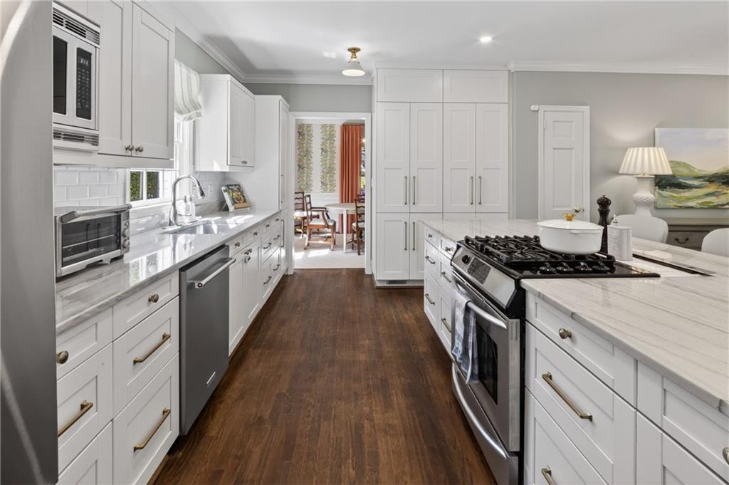 755 Greenview Avenue Northeast Atlanta, GA 30305 - Photo 9 of 28 a large kitchen with stainless steel appliances lots of counter space and wooden floor