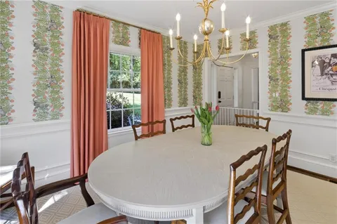 a dining room with furniture and wooden floor
