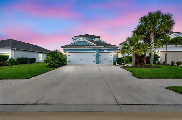 a front view of a house with a yard and garage