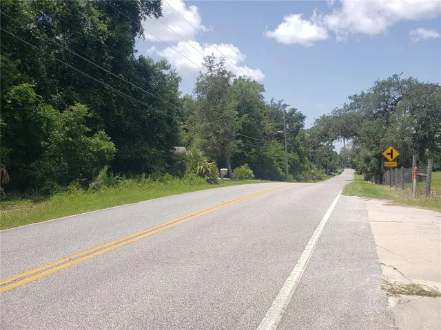 a view of road with grass and a trees