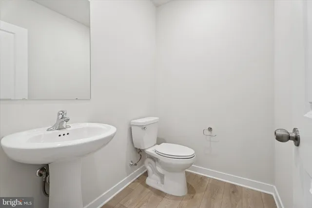 a bathroom with a sink a toilet and mirror