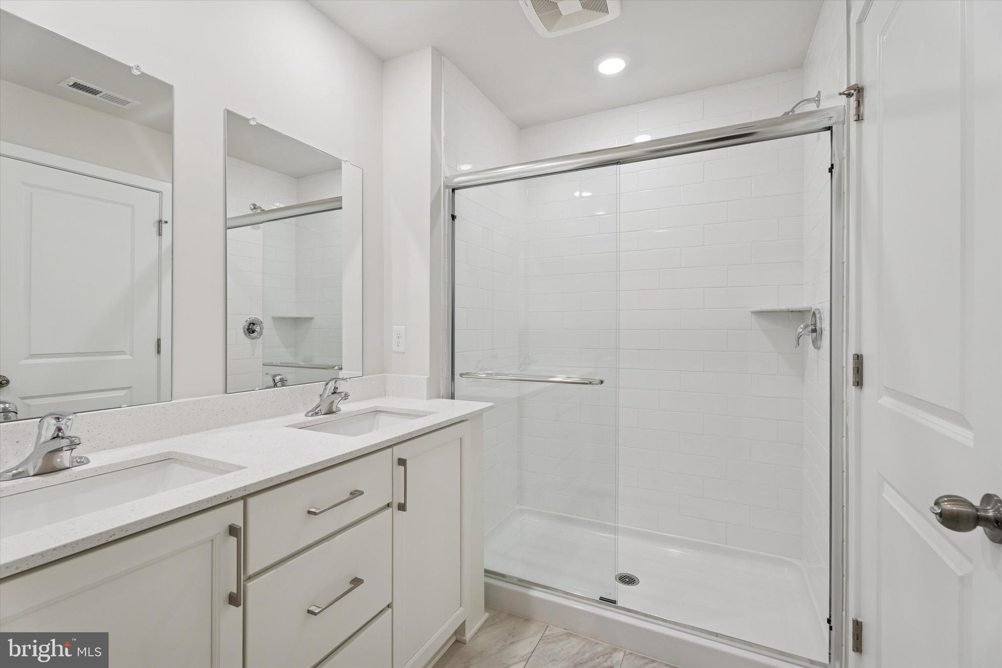 19 East Front Street Bridgeport, PA 19405 - Photo 20 of 25 a bathroom with a shower sink vanity and mirror
