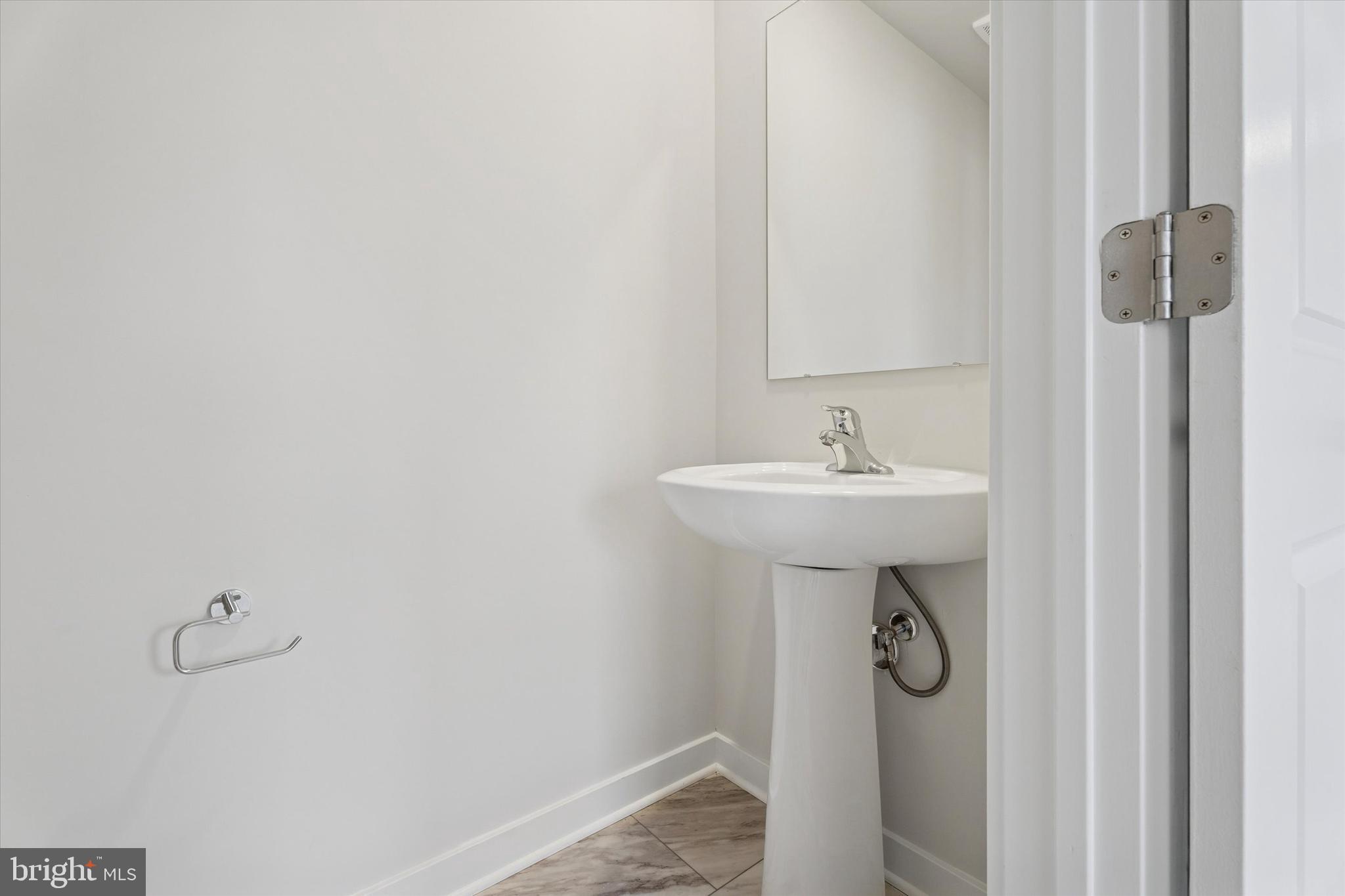 19 East Front Street Bridgeport, PA 19405 - Photo 23 of 25 a bathroom with a sink and a mirror