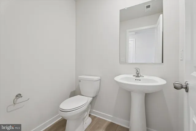 a bathroom with a sink a toilet and mirror