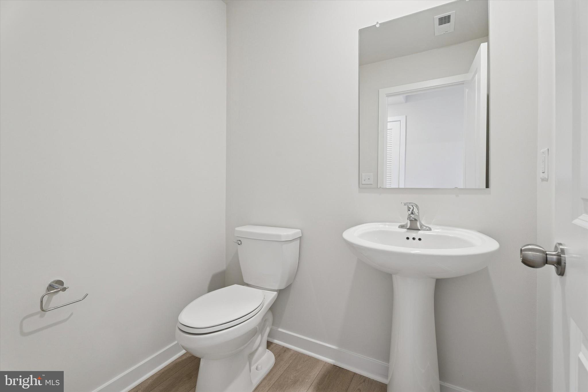 19 East Front Street Bridgeport, PA 19405 - Photo 4 of 25 a bathroom with a sink a toilet and mirror