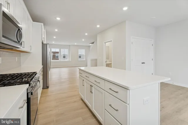 a kitchen with cabinets and a stove