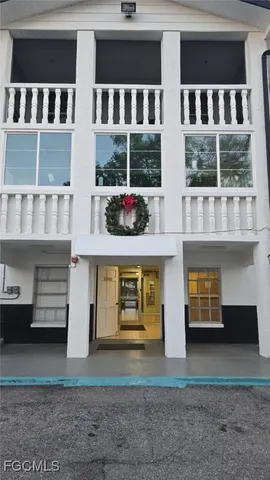 a front view of a building with a yard