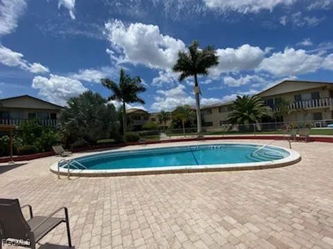 a view of a swimming pool with a yard