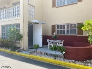 a front view of a house with swimming pool and porch