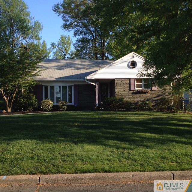 163 Normandy Road Colonia, NJ 07067 - Photo 1 of 14 a front view of a house with a garden