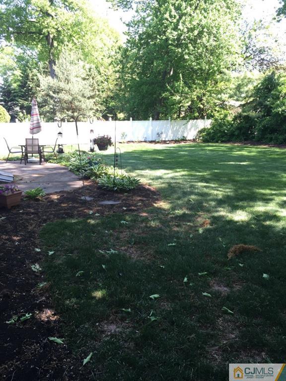 163 Normandy Road Colonia, NJ 07067 - Photo 14 of 14 a backyard of a house with lots of green space and fountain