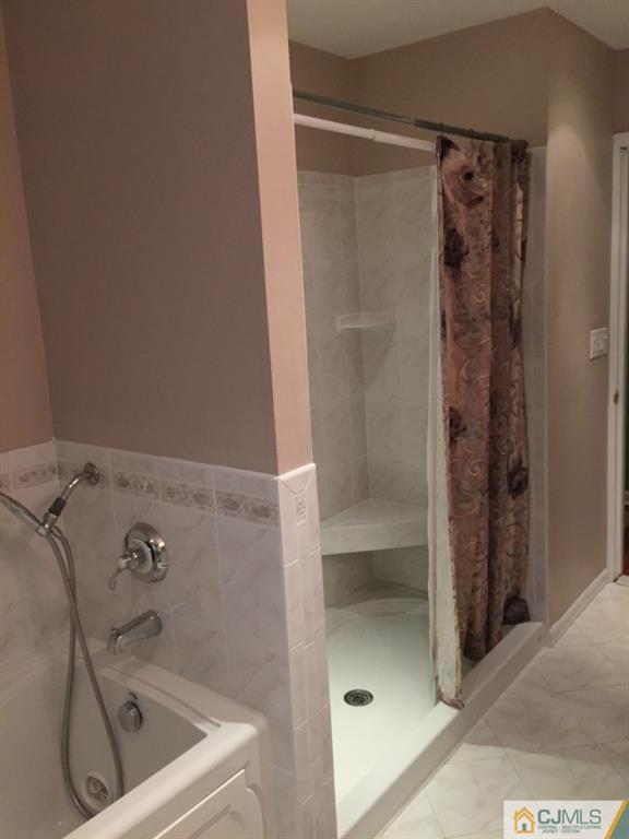 163 Normandy Road Colonia, NJ 07067 - Photo 5 of 14 a bathroom with a tub and shower