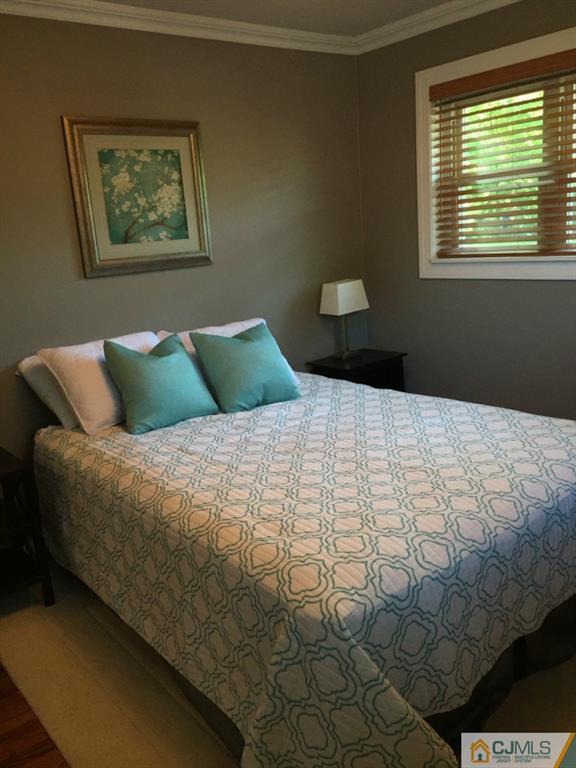 163 Normandy Road Colonia, NJ 07067 - Photo 6 of 14 a bedroom with a bed and a window