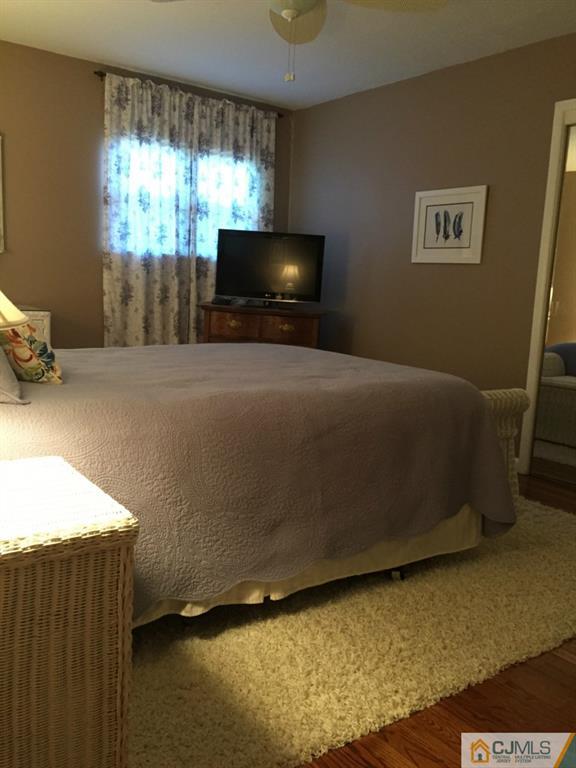 163 Normandy Road Colonia, NJ 07067 - Photo 8 of 14 a bedroom with a bed and a flat screen tv