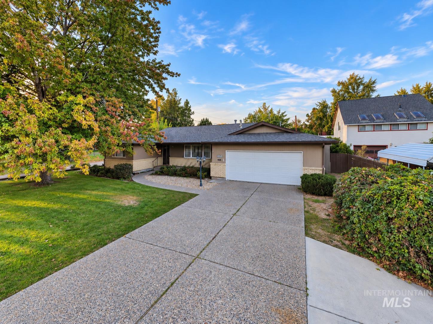 340 Pioneer Road Weiser, ID 83672 - Photo 42 of 44 Ranch-style exterior with a stucco finish, attached two-car garage, and a concrete driveway
