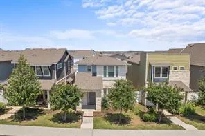 a kitchen with stainless steel appliances granite countertop a refrigerator a stove and a wooden floors