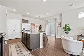 a kitchen with stainless steel appliances granite countertop a sink a stove and a refrigerator