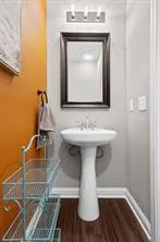 a bathroom with a sink toilet and mirror