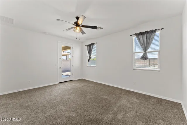 a view of a livingroom with a ceiling fan and entryway