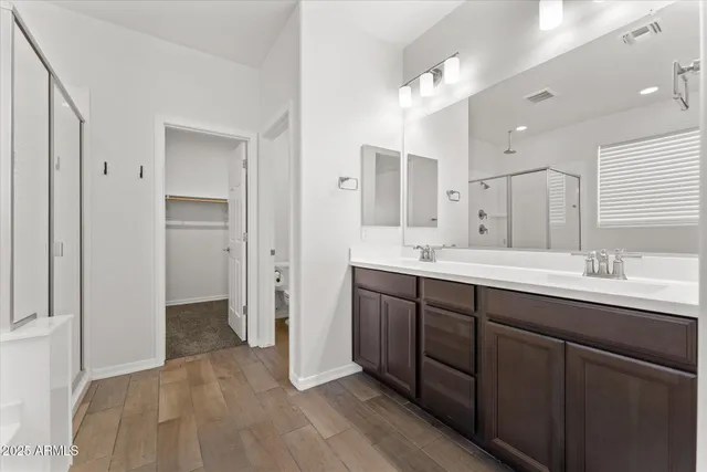 a spacious bathroom with a sink double vanity and shower