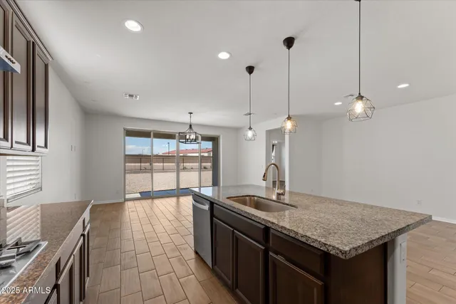 a view of a kitchen with granite countertop cabinets