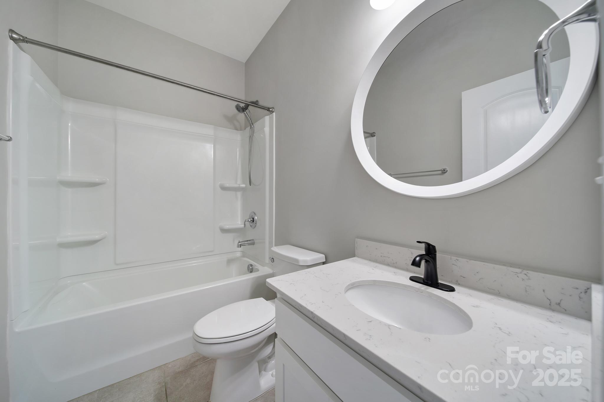 17237 Rider Wood Lane Charlotte, NC 28278 - Photo 14 of 43 a bathroom with a sink a toilet and a mirror