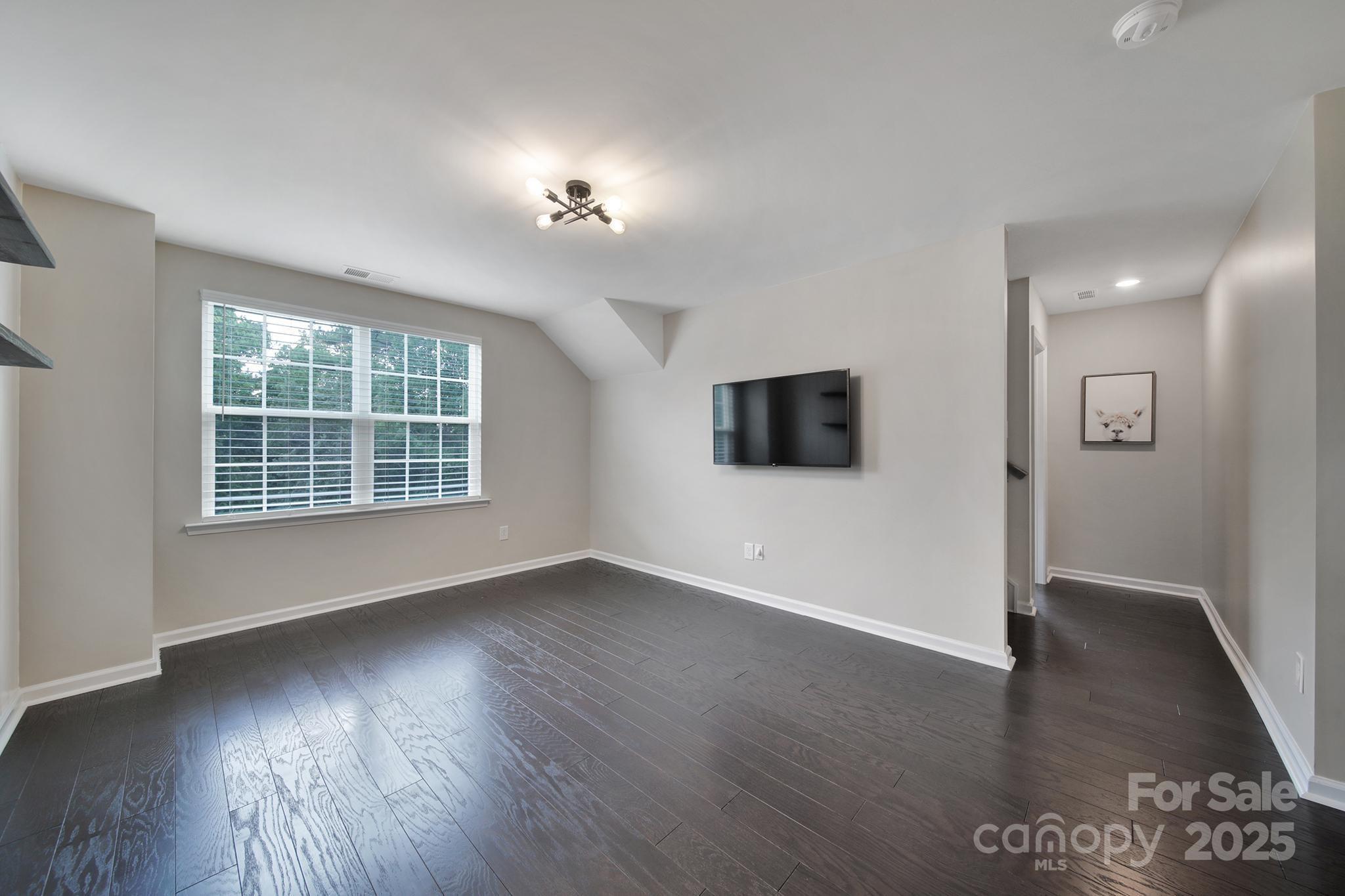 17237 Rider Wood Lane Charlotte, NC 28278 - Photo 17 of 43 an empty room with wooden floor and windows