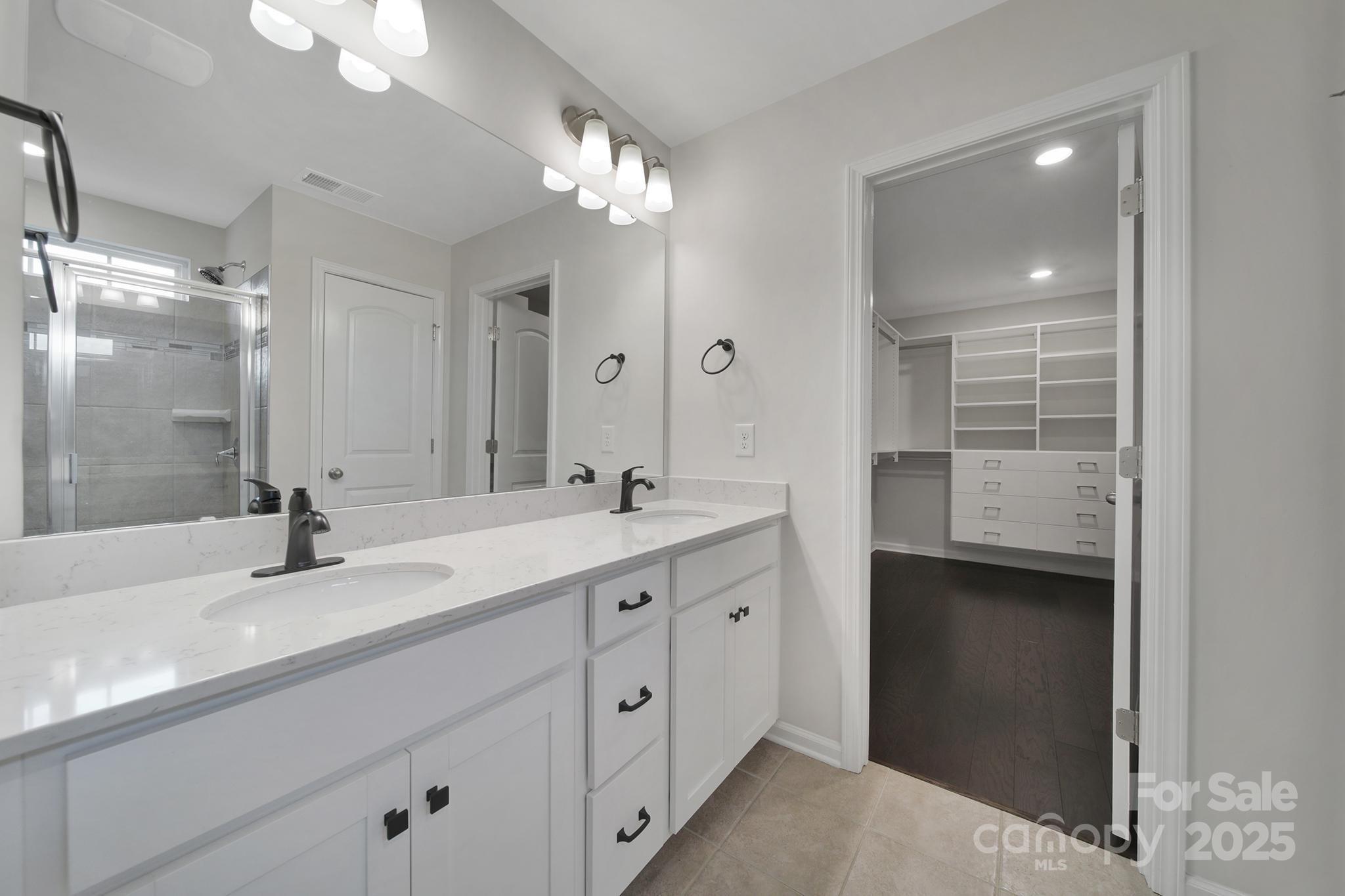 17237 Rider Wood Lane Charlotte, NC 28278 - Photo 21 of 43 a bathroom with a double vanity sink and a mirror