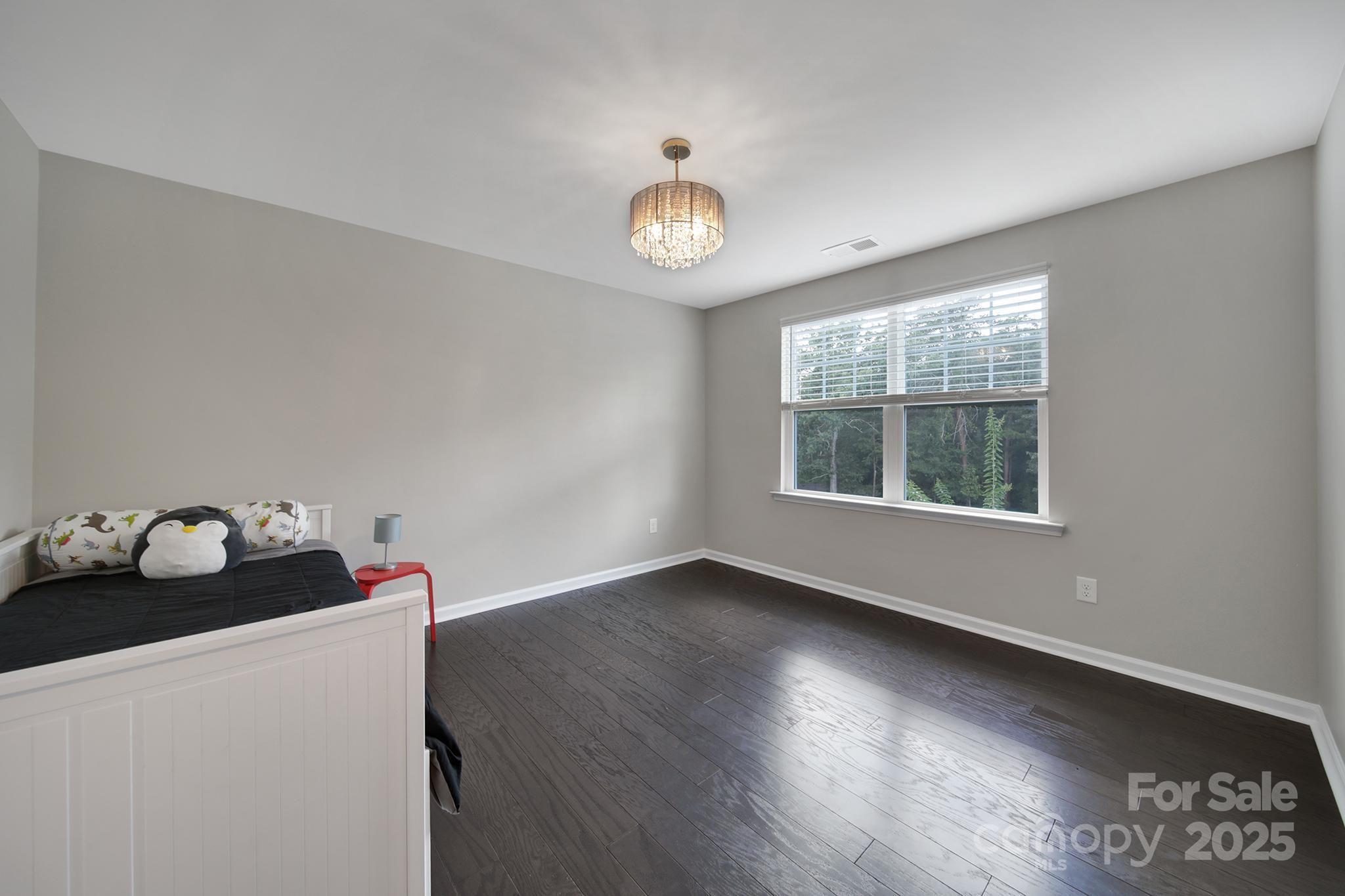 17237 Rider Wood Lane Charlotte, NC 28278 - Photo 28 of 43 a view of an empty room with wooden floor and a window