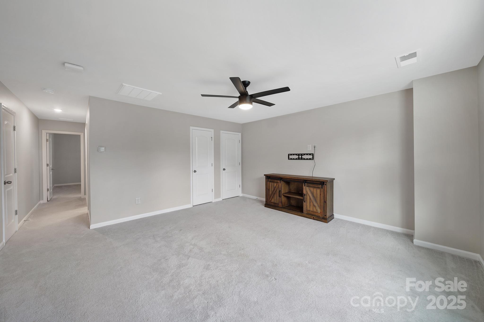 17237 Rider Wood Lane Charlotte, NC 28278 - Photo 32 of 43 a view of an empty room with a ceiling fan