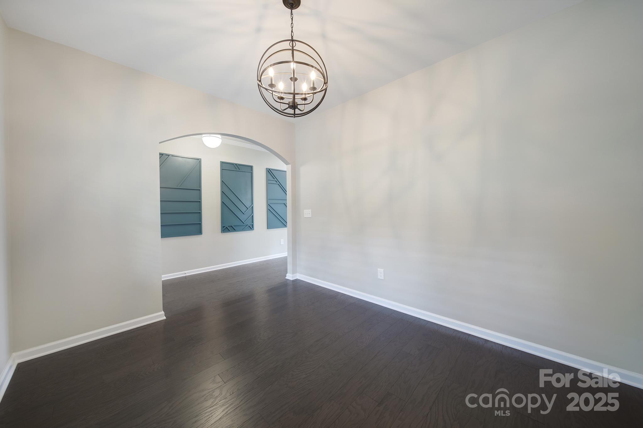 17237 Rider Wood Lane Charlotte, NC 28278 - Photo 4 of 43 an empty room with wooden floor and windows