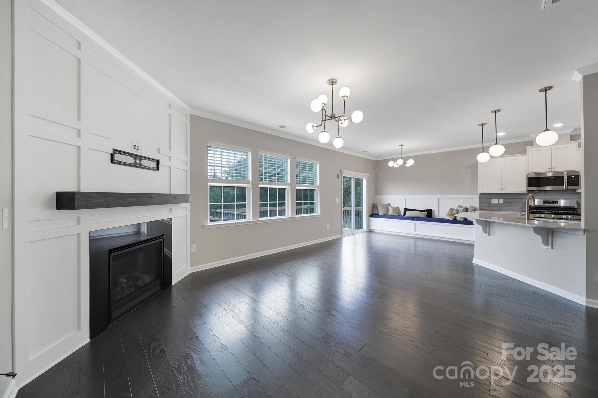 17237 Rider Wood Lane Charlotte, NC 28278 - Photo 8 of 43 a view of an empty room with kitchen and fireplace
