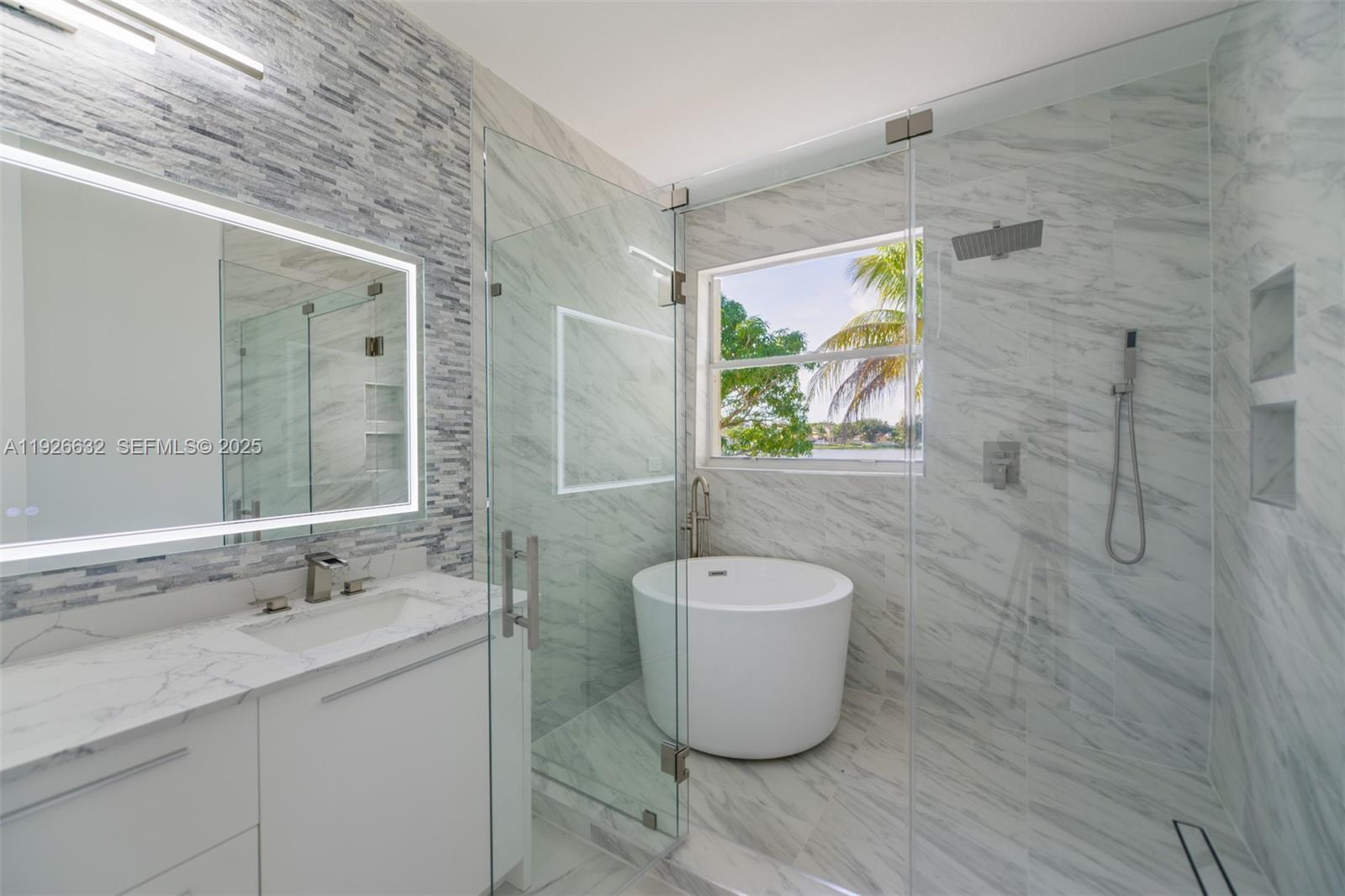 5290 Southwest 134th Avenue Miramar, FL 33027 - Photo 16 of 44 a bathroom with a granite countertop sink and a mirror
