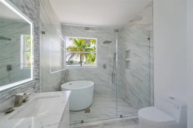 an empty room with windows and cabinet