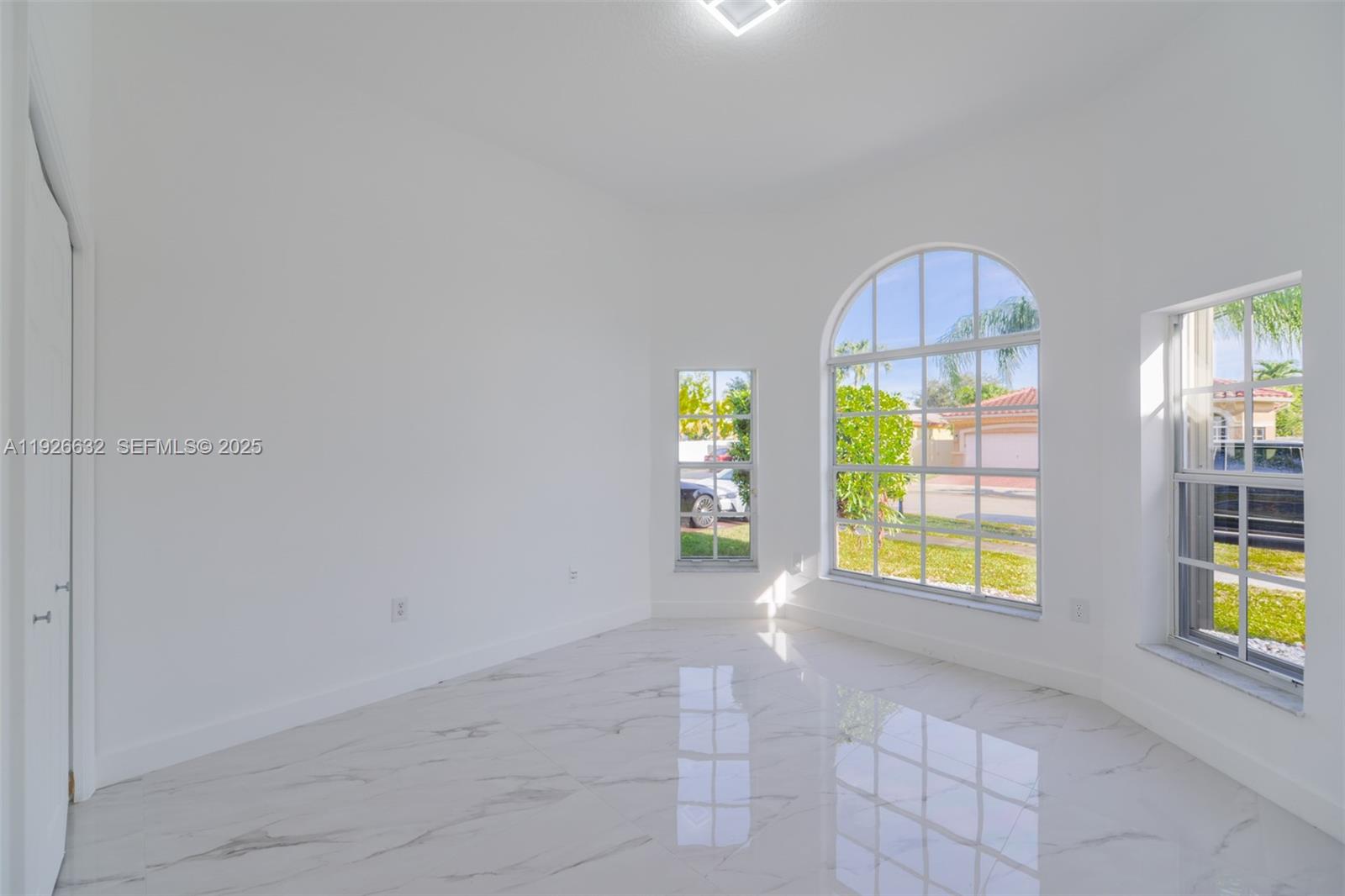5290 Southwest 134th Avenue Miramar, FL 33027 - Photo 19 of 44 an empty room with windows and cabinet