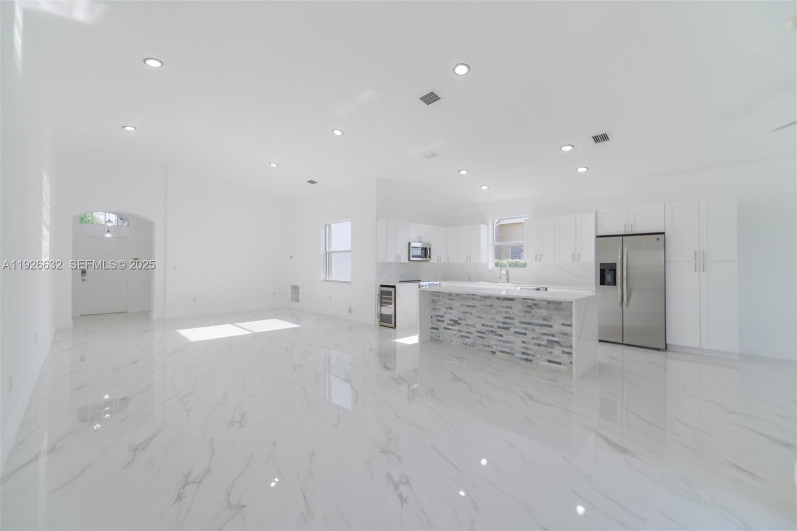 5290 Southwest 134th Avenue Miramar, FL 33027 - Photo 2 of 44 a bathroom with a sink and a large mirror